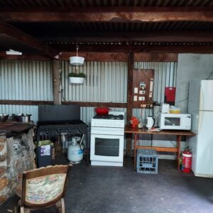 Inside kitchen with open fire, BBQ, fridge/freezer, stove, oven, microwave, kettle and toaster